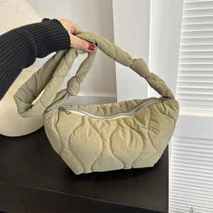 Quilted puffer shoulder bag in khaki green with wave stitching and zip closure