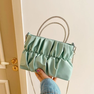 Mint green pleated handbag with sparkling rhinestone handles and golden chain strap