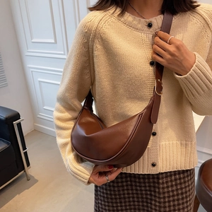 Brown vintage hobo saddle bag for women featuring soft leather and golden hardware details