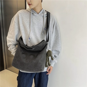 Large dark grey canvas messenger bag with embossed 100 lettering and crossbody strap
