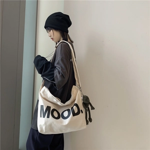 Japanese style beige canvas tote bag with MOOD lettering and cute green frog pendant