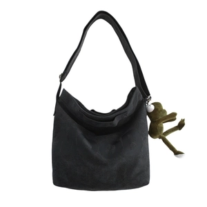 Black canvas hobo shoulder bag with frog plush charm and adjustable strap for women