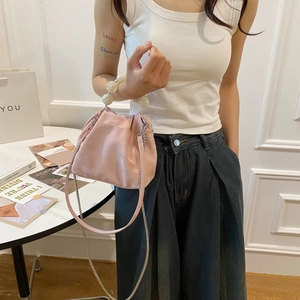 Pink pleated cloud bag with oversized pearl handle and metallic chain strap detail
