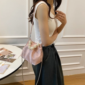 Chic light pink pleated cloud bag with large pearl accents and silver chain strap