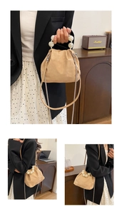 Detail of beige matte bucket bag with marble pearl handle and metal chain strap