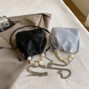 Detail of macaron matte cloud bags with marble bead handles and metal chain straps
