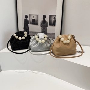 Detail view of cloud pouches in black silver and camel with oversized pearl handles