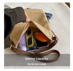 Detailed view of the straw bag internal capacity with essentials like umbrella and phone