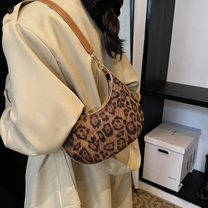 Fashionable leopard print crescent hobo bag with sleek leather strap and gold hardware