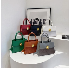 Detailed arrangement of crossbody bags with crocodile texture and gold metal locks