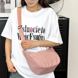 Pink minimalist crossbody dumpling bag with wide adjustable strap for casual daily use