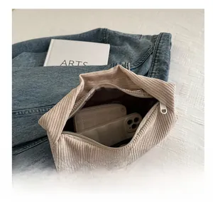 Interior view of beige corduroy pouch showing space for mobile phone and wallet