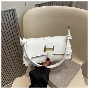 Detail of white leather shoulder bag featuring gold H-buckle and knotted handle design