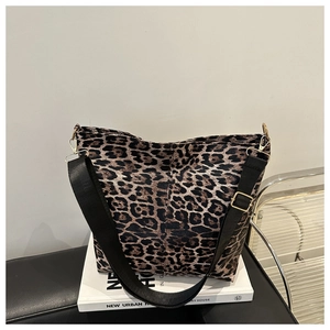 Detail of leopard print tote bag with black wide strap and golden metal hardware