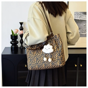 Stylish leopard print canvas shoulder bag with brown strap and cloud plush charm detail