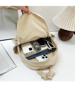 Interior view showing the large storage capacity of this cream corduroy messenger bag