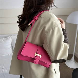 Fashionable rose pink leather shoulder bag with metallic clasp and knot strap design