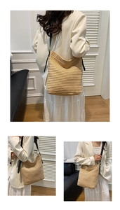 Detail of a large woven straw hobo bag with slim black leather shoulder straps