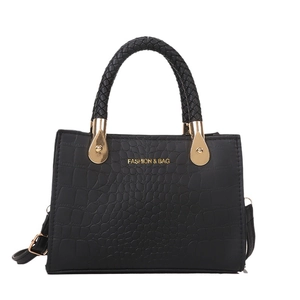 Classic black crocodile pattern handbag with woven handles and gold metal accents