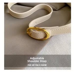 Close-up of adjustable cream PU leather strap with gold buckle and neat stitching details