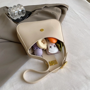 Spacious off-white hobo bag showing interior capacity for umbrella and cosmetics