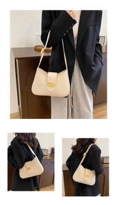 Detail view of the beige crescent hobo bag featuring adjustable strap and golden buckle