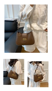 Detail of a brown matte leather shoulder bag with a vintage gold rectangular buckle