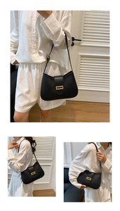 Detail of minimalist black underarm bag featuring a metallic gold rectangle clasp and matte leather