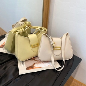 Detail of macaron-colored crescent bags with golden hardware and smooth leather finish