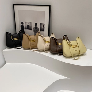 Selection of macaron-colored shoulder bags with elegant gold metal buckles in a modern display