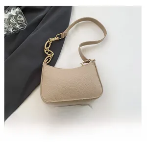 Crocodile pattern underarm bag in beige with gold chain and phone for size comparison