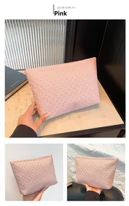 Detail of pink woven envelope clutch bag showing texture and color display