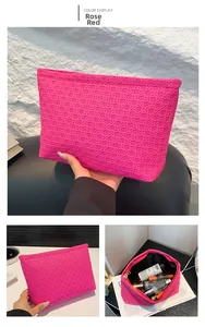 Detail of rose red envelope clutch with cross-weave texture and metal zipper closure