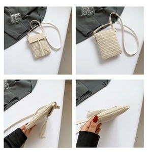 Detail view of beige woven mini phone crossbody bag with tassel and leather strap