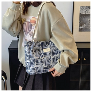 Blue and white geometric tote bag styled with casual outfit for a chic daily commute look
