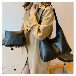 Detail of minimalist black large tote bag set including a small zippered pouch