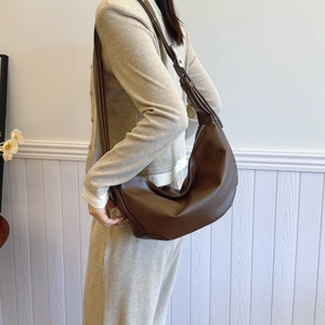 Large brown soft leather crescent hobo shoulder bag with adjustable strap in casual style