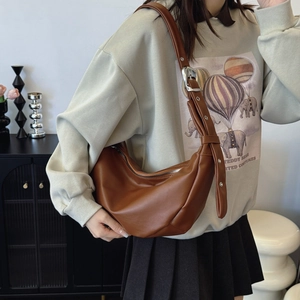 Brown soft leather hobo bag with adjustable wide strap and silver hardware accents