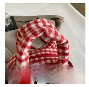 Detail of soft plush bowling bag with red and white plaid pattern and thickened handle