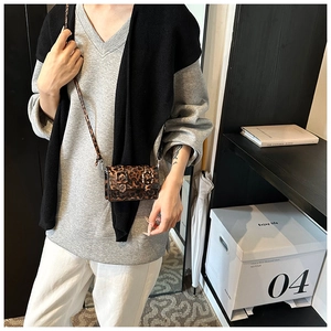 Detail of leopard print mini crossbody bag with double buckles and slim shoulder strap