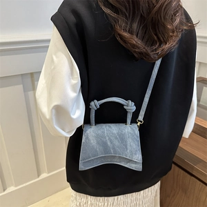 Light blue denim texture hourglass handbag with knot handle and crossbody strap