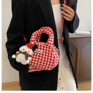 Detail of red and white checkered plush handbag with a cute Christmas puppy charm