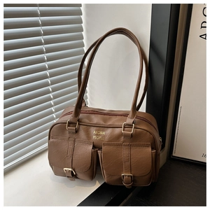 Close-up of brown PU leather bag featuring gold buckles and two front flap pockets
