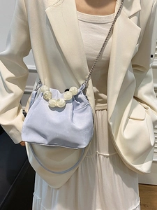 Light blue cloud crossbody bag with large pearl handle and silver chain on model