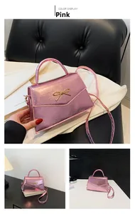 Sac rose aspect métallique avec nœud doré et poignée élégante pour femmes