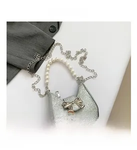 Detailed macro view of silver glitter fabric with metal bow and pearl handle texture