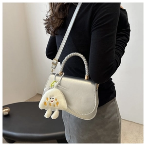 Silver metallic crossbody bag with woven handle and cute white plush charm detail