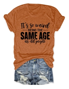 Mise à plat d'un t-shirt orange avec slogan et d'un short en jean délavé