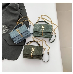 Three minimalist flap square bags in denim blue and green with gold metal S logo