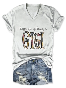Detail view of V-neck white T-shirt with GIGI floral text and denim shorts